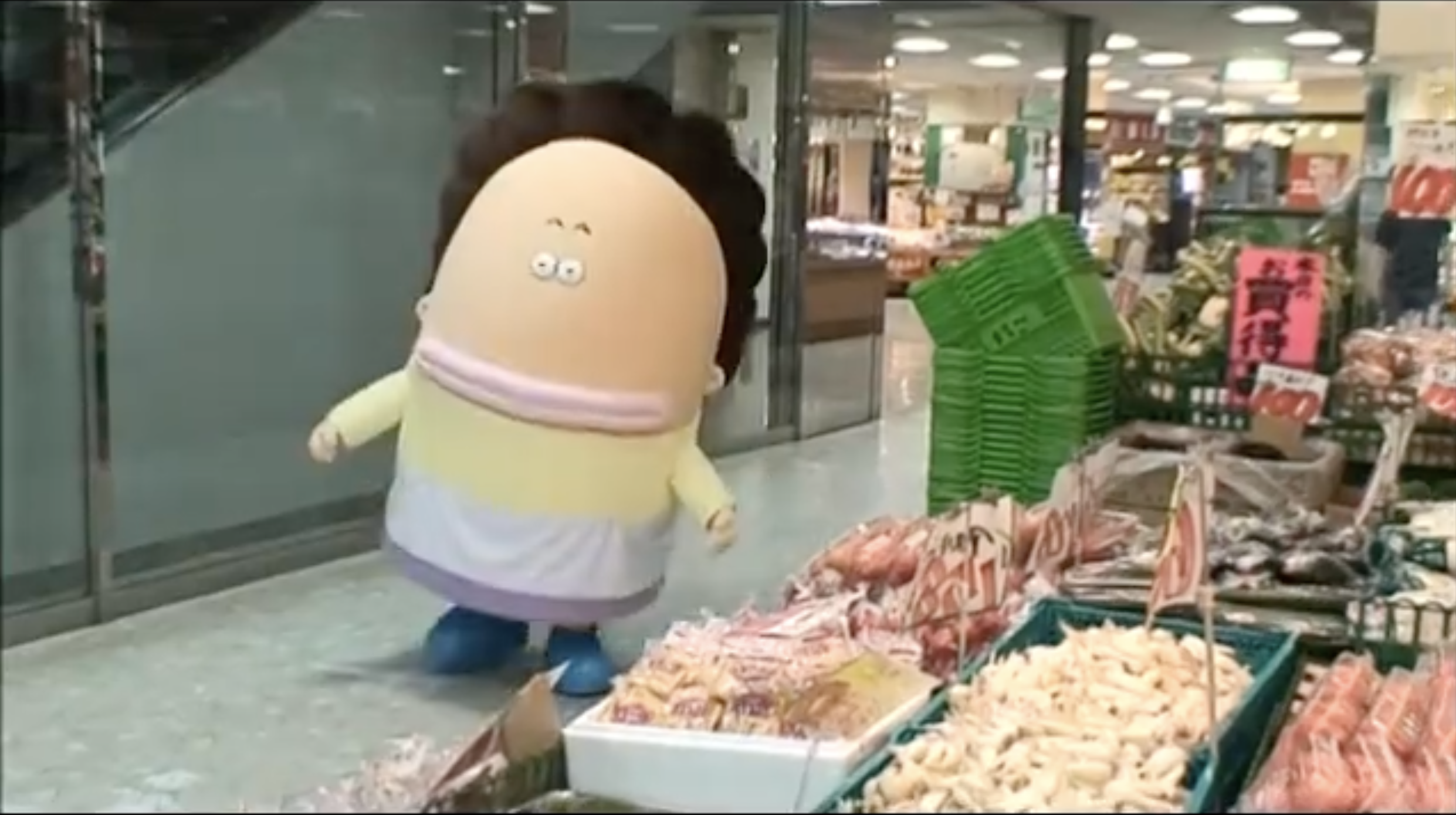 a mascot of a character called Okaa-san Tachibana from japanese anime 
        'Atashin'chi' shopping in a farmer's market, on the right side of image there're baskets of plastic packaged snacks